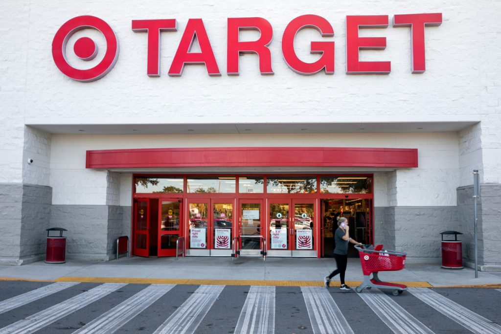 Une femme sort de la cible tout en parlant au téléphone.