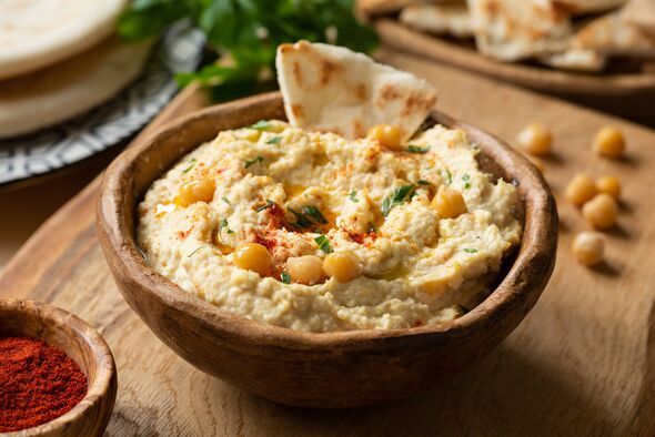 Bol de houmous de pois chiches maison avec chips de pita et paprika. Vue rapprochée, mise au point sélective Bol de houmous de pois chiches maison avec chips de pita et paprika. Vue rapprochée, mise au point sélective